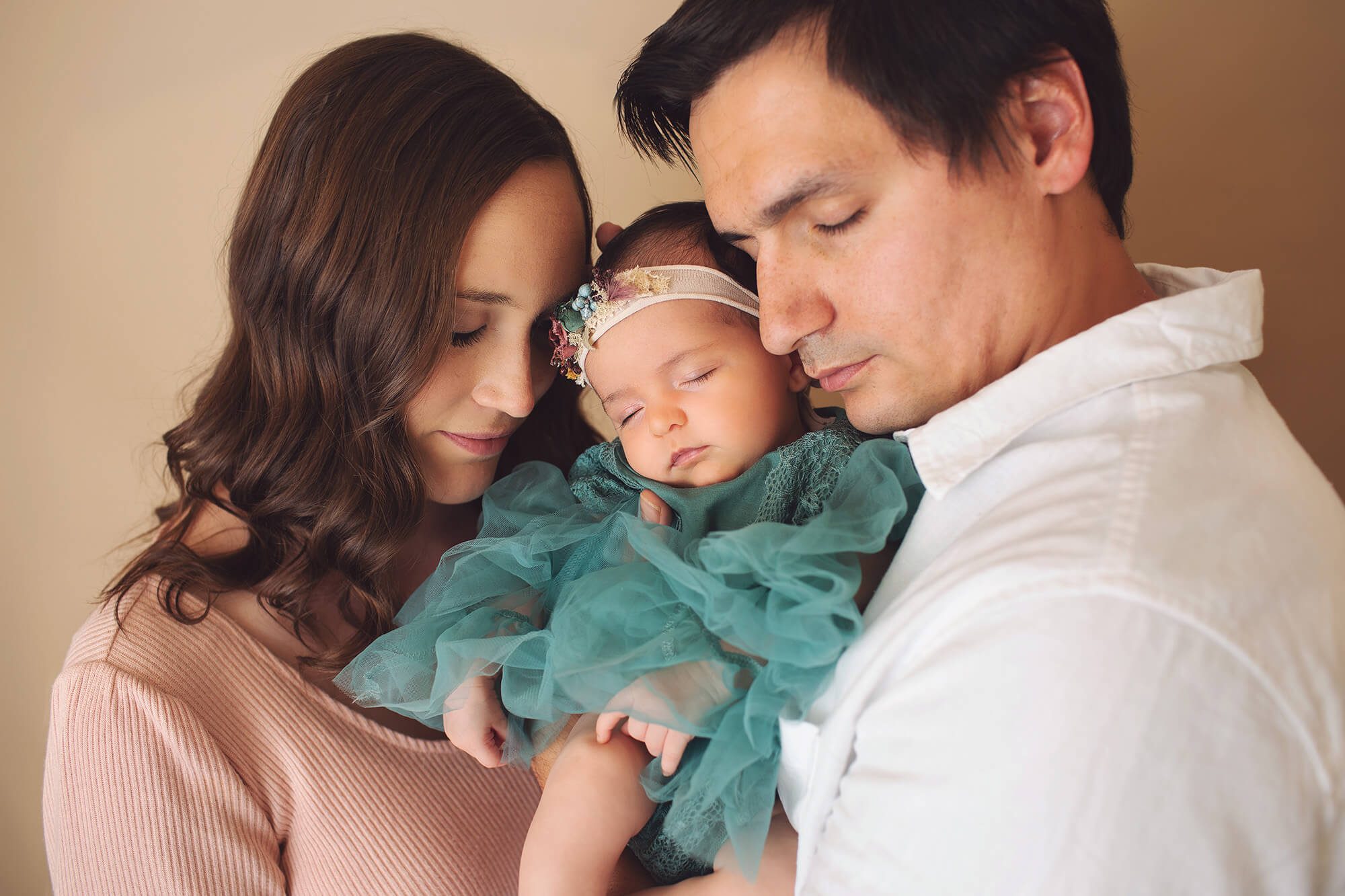 Mom, Dad, and baby Amelia snuggle together