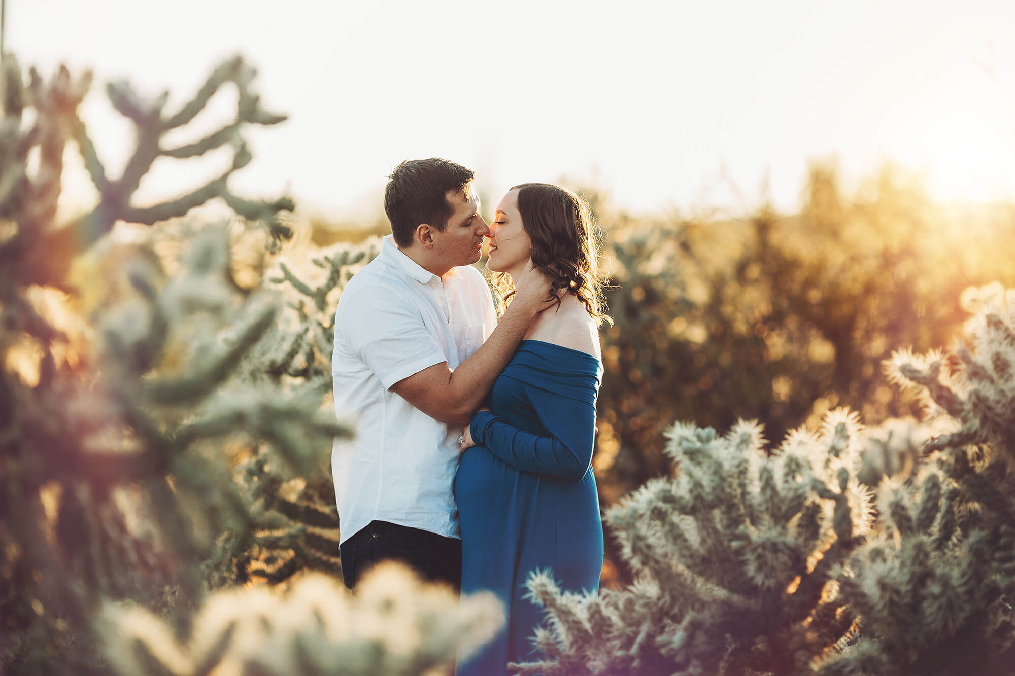 A sweet kiss during Adrianne's maternity session at Sabino