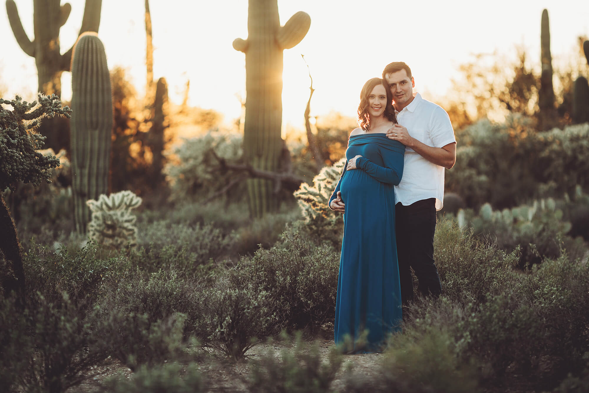 The setting sun behind one of the giant saguaros at Sabino canyon during Adrianne's maternity session