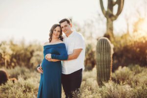 Sweet mom and dad to be holding one another during their Sabino canyon maternity session