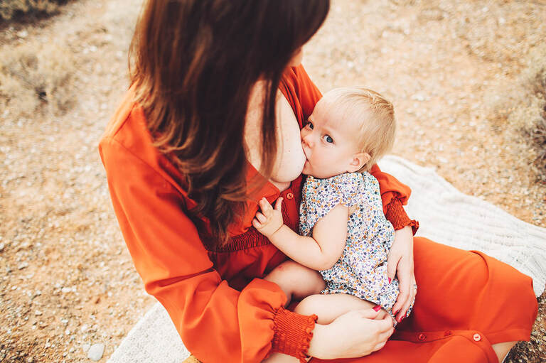 Baby girl nursing with mom
