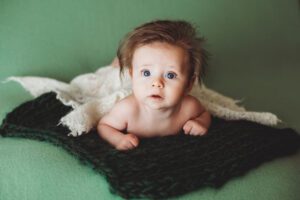 The green backdrop was beautiful with his bright blue eyes