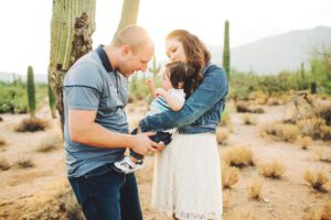 Playful interactions with baby Easton for mom and dad during their sunrise family session