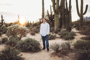 Giant saguaros at his back, Cory laughs