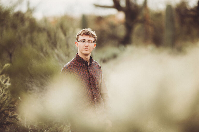 Surrounded by cactus during Cory's senior session