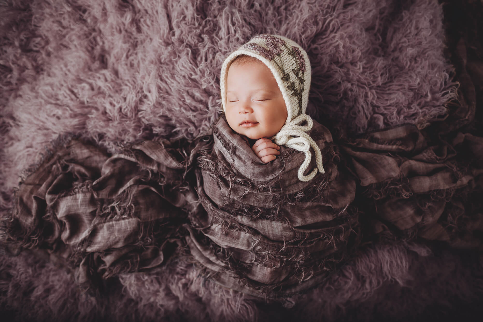 Newborn baby Rubi in lavender with a lavender bonnet