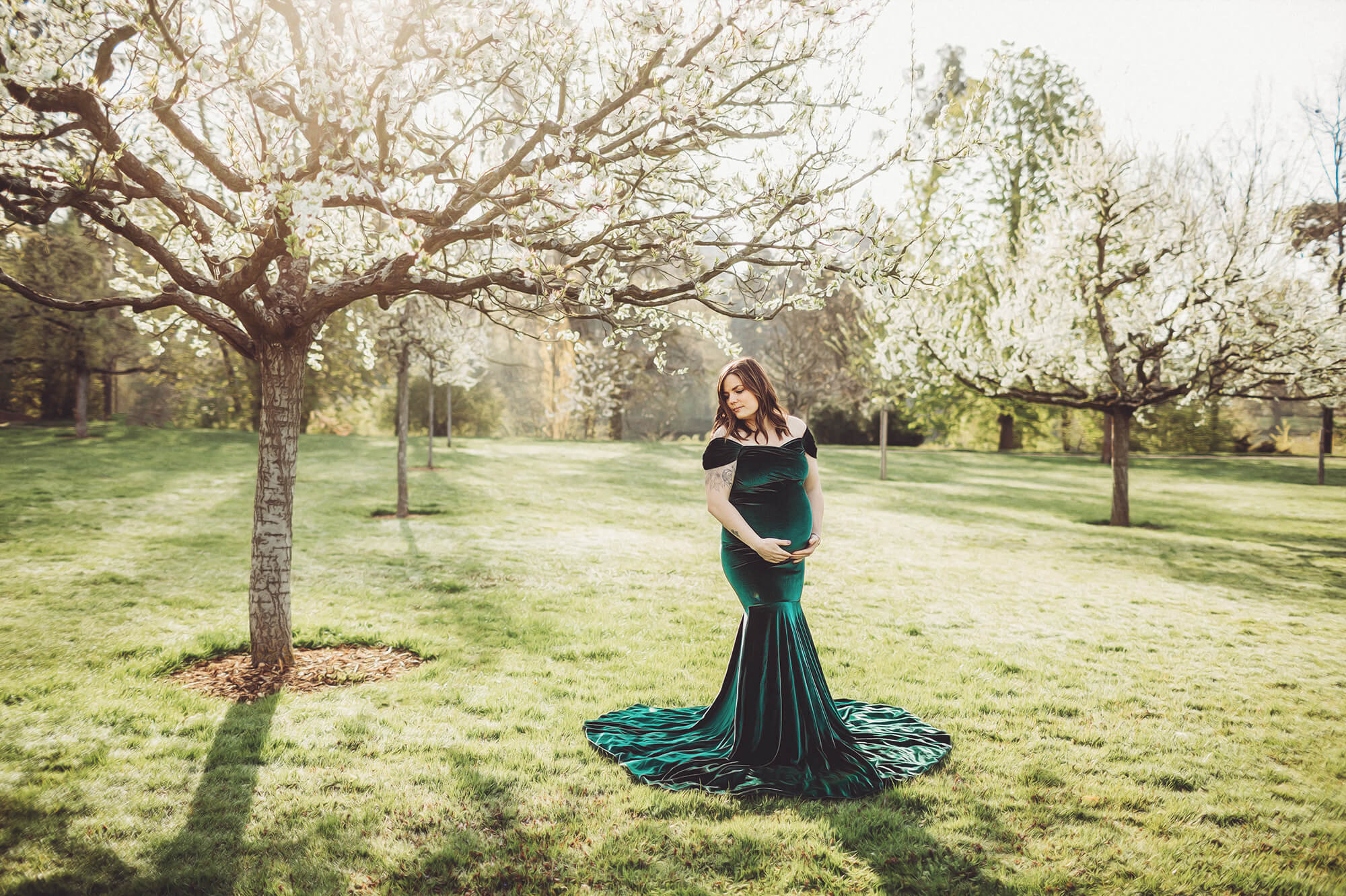 Christina posed in her green velvet gown under the spring blossoms in the early morning light.